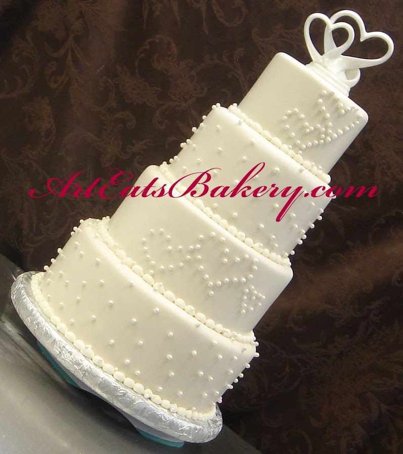 Four tier fondant wedding cake with sugar pearls and hearts