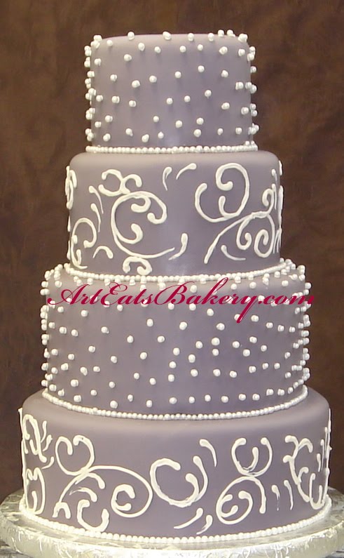 Four tier purple fondant wedding cake with sugar pearls and white royal 