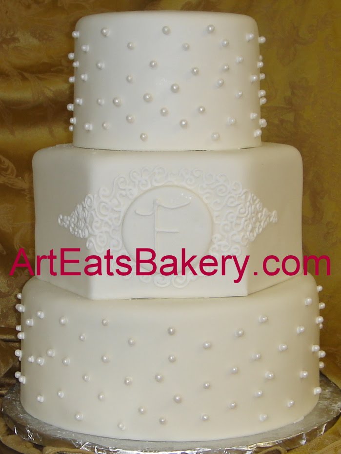  white fondant wedding cake with sugar pearls monogram and curlicues